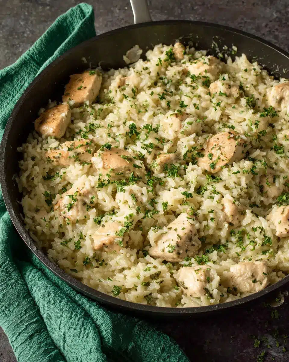 Creamy Chicken and Rice Family Skillet Creamy one pan chicken and rice skillet with green towel