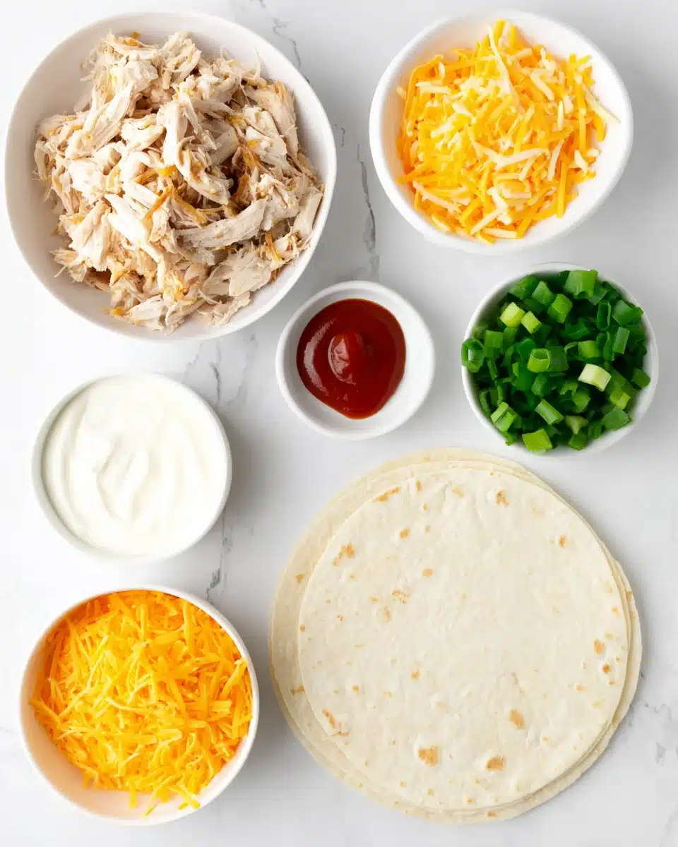 Hand holding cheesy garlic chicken wrap with melted cheese and chicken filling.